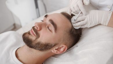 Young man with hairloss problem receiving injections in scalp by trichology doctor